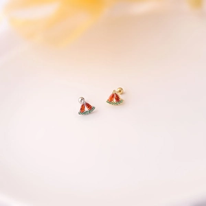Detailed macro view of creative watermelon stud earrings with red and green zircons