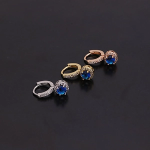 Detailed close-up of mini flower zircon hoop earrings in gold, silver and rose gold