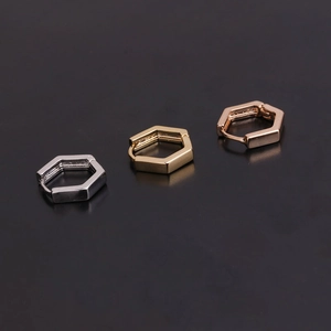 Detailed view of hexagonal huggie earrings in silver, gold, and rose gold finishes