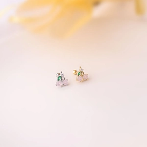 Macro shot of gold and silver cherry fruit earrings with colorful zircon and ball screw backings