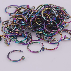 Close-up of rainbow plated C-shaped 316L stainless steel nose rings with flat ends