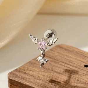 Pink star and angel wings helix stud earring with cross pendant on wood background