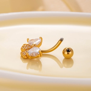 Macro shot of gold butterfly navel ring with crystal pavé and screw ball structure