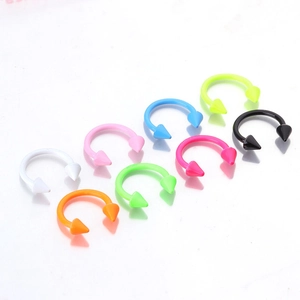 Detail of colorful horseshoe rings with spikes for nose and lip piercing set