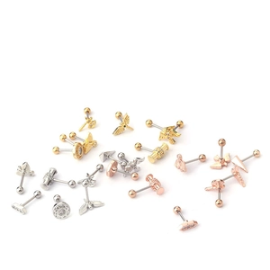 Detailed macro of stainless steel barbell piercings in gold, silver and rose gold finishes