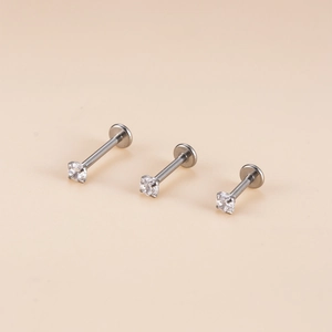 Three pieces of silver surgical steel labret studs with clear round zircon in a four-prong setting