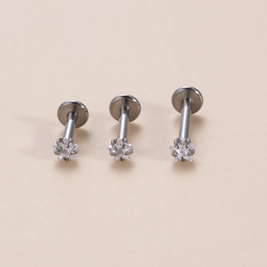 Three stainless steel labret studs with star-shaped zircon inlays in varying stem lengths