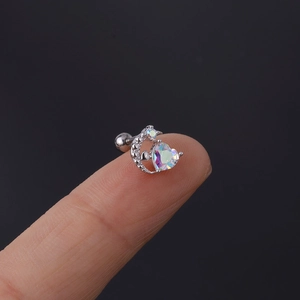 Nahaufnahme von Mond-Herz-Helix-Stecker aus Edelstahl 20G zwischen den Fingern