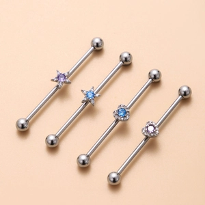 Macro shot of industrial barbells with star and heart sliders featuring colorful zircons
