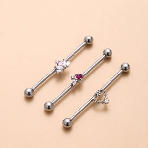 Three industrial piercing barbells with colorful zircon hearts on surgical steel rods