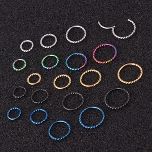Nahaufnahme von gedrehten Edelstahl-Clicker-Ringen in fünf Farben und verschiedenen Größen