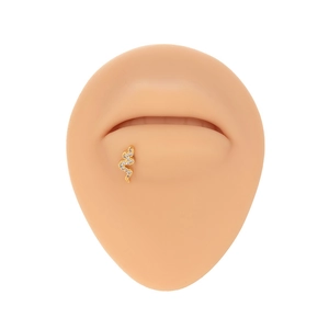 Detailed view of a gold-plated snake labret stud with white cubic zirconia on a lip model