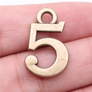 Vintage bronze number 5 pendant charm held on fingertip for DIY jewelry making