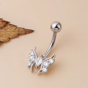 Silver butterfly navel ring with sparkling zircon stones on a beige background