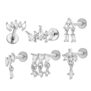 Titanium flat back studs with zircon diamond crown and geometric designs on white background