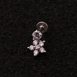 Macro view of flower zircon labret stud with stainless steel flat back piercing detail