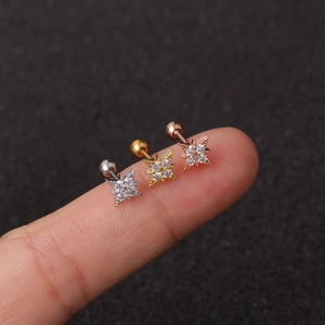 Detailed view of rose gold, gold, and silver star stud earrings with zircon inlays