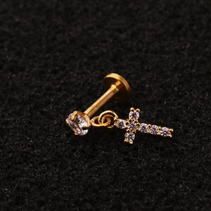 Close-up of gold cross pendant labret stud with pavé zircon and flat back structure