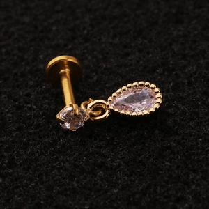 Macro shot of gold stainless steel stud featuring a pear-shaped cubic zirconia dangle