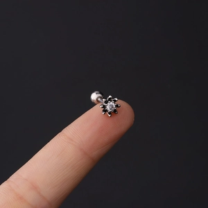 Macro view of 16G stainless steel sunflower ear stud with a sparkling zircon inlay