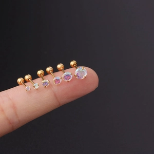 Detailed close-up of six gold-plated stainless steel stud earrings with AB zircon on a finger