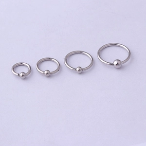 Polished silver stainless steel seamless rings in four sizes for body piercings