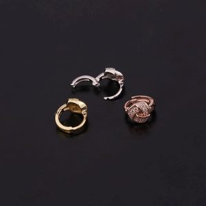 Star zircon ear hoops in gold, silver and rose gold finishes on black background