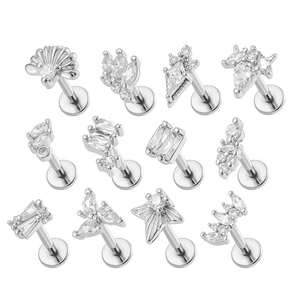 Set of 11 titanium steel labret studs with various zircon shapes on white background