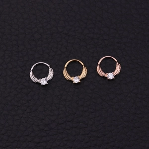 Tribal septum ring set in silver, gold, and rose gold with zircon and feather wings