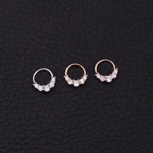 Three-piece tribal septum rings set in gold, silver, and rose gold with zircon accents