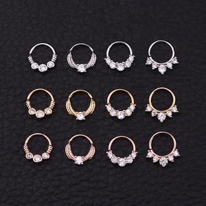 Set of 12 copper zircon nose rings in silver, gold and rose gold on black leather