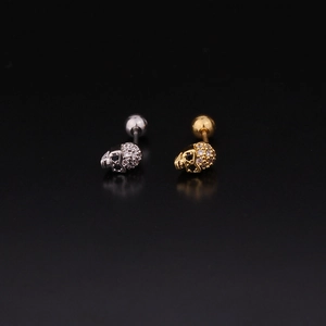 Vue détaillée des boucles d'oreilles crâne en argent et or avec zircons cubiques brillants