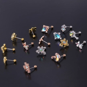 Detailed flat lay of moonstone stud earrings in silver, gold and rose gold finishes