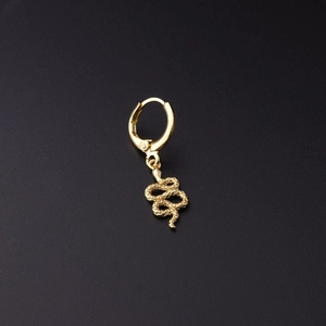 Polished gold snake pendant drop earring with textured scales on a minimalist black background