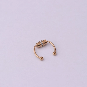 Close-up of rose gold magnetic septum ring with small ball ends and U-shaped design