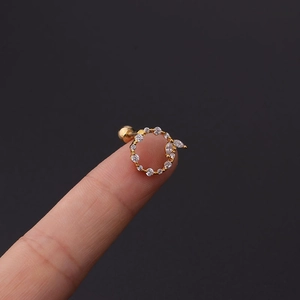 Macro shot of 16G gold plated earring with white cubic zirconia and screw-back ball
