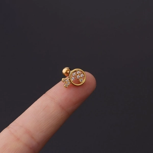 Macro view of gold fish stud earring featuring white zircon pavé and screw ball back