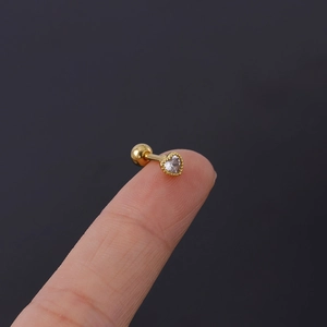 Detail of a 16G gold heart cartilage stud with screw ball back shown on a fingertip
