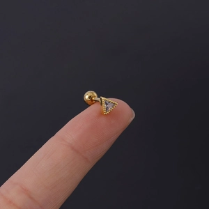 Close-up of golden triangle cartilage stud earring with clear zircon and screw back