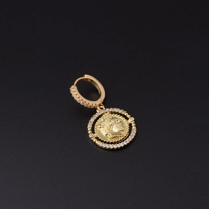 Detail of gold coin drop earring with micro-paved zircons and vintage relief