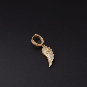 Close-up of a gold-plated angel wing huggie earring with micro-pave zirconia details