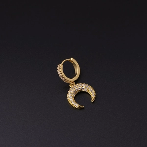 Detailed macro view of gold crescent moon earrings with micro-set white zircon stones