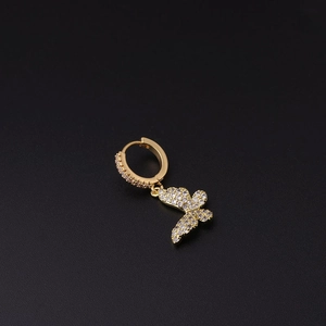 Detailed view of a gold-plated earring with butterfly pendant and micro-set white zircons