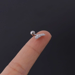 Detailed view of 16G stainless steel helix stud with five clear curved cubic zirconia stones