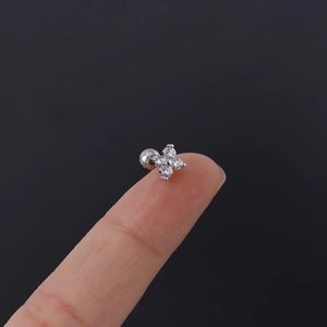 Macro shot of silver clover cartilage stud with clear zircons and screw back ball