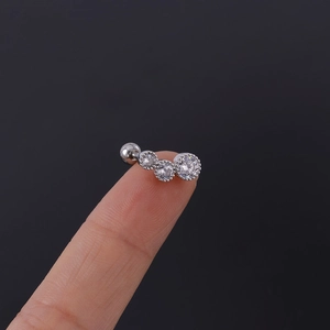 Macro shot of 16G silver stainless steel cartilage stud with three curved zircons