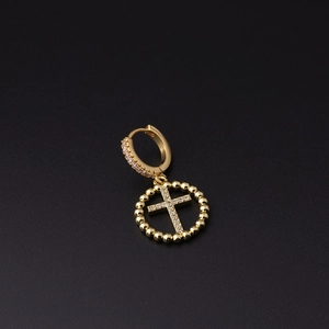 Detail of gold-plated hoop earring with micro-paved cross pendant and zircon stones