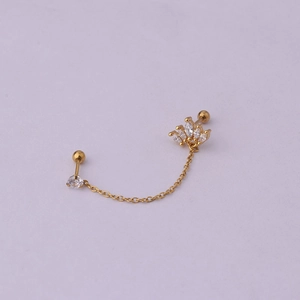 Detail of gold chain earring featuring a zircon crown and stud for double piercings