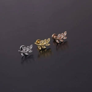 Detailed view of leaf-shaped labret studs in silver, gold, and rose gold with zircon