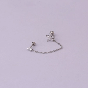 Detail of integrated double stud earrings with flower design and delicate silver chain
